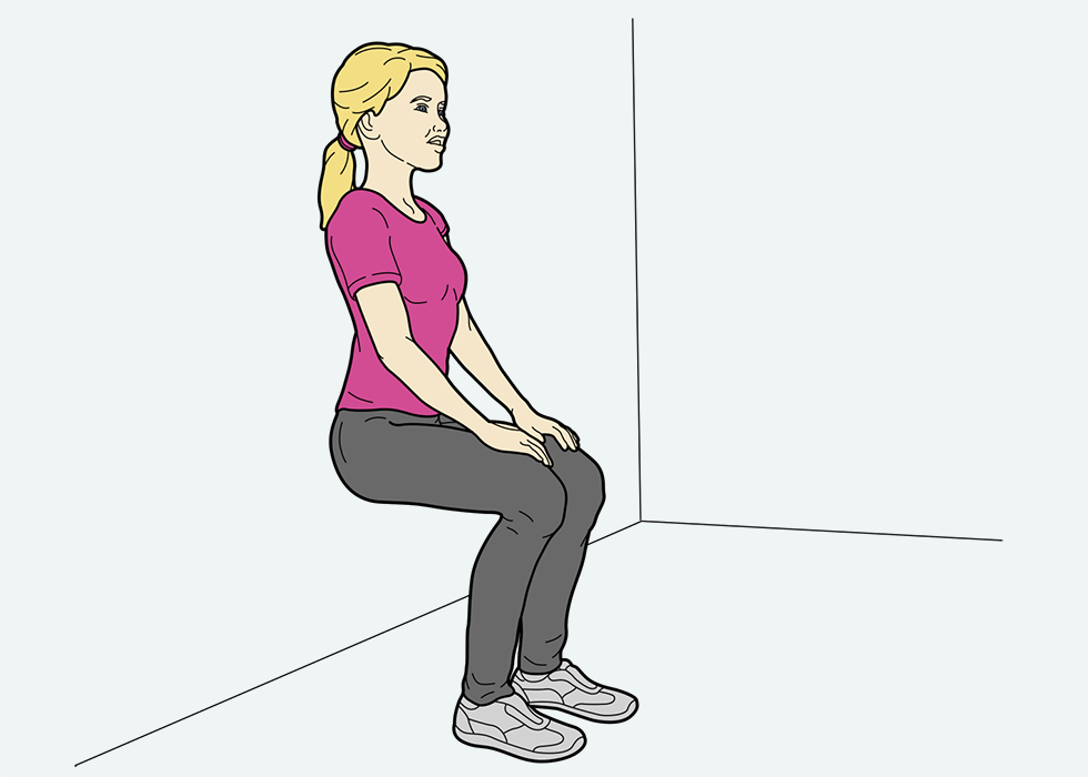 Person squatting against a wall.