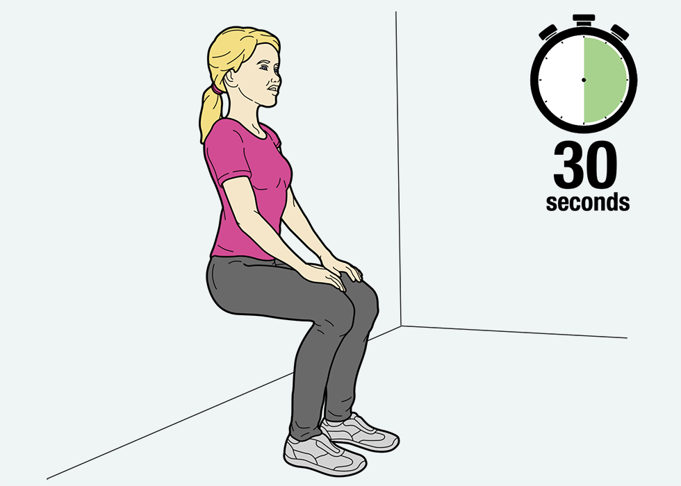 Person squatting against a wall with a 30 second timer